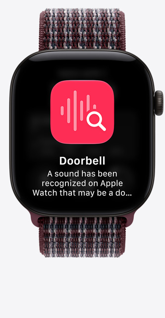 Apple Watch Series 12, a kijelzőn az ajtócsengő hangfelismerése látszik, fekete alumíniumtok, bordeaux plázlis sportpánt