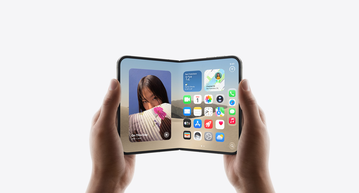 iPhone Duo, held by two hands in open landscape position, inside exterior, Star White colour, iOS home screen display, photos on the left, apps on the right