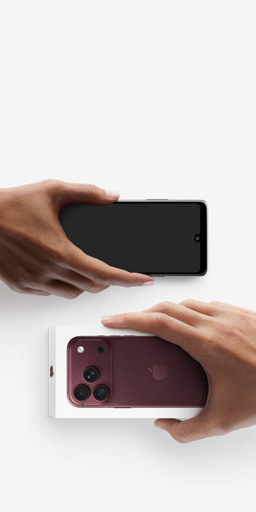 Hands exchanging phones, Android on the left without box, new iPhone 18 Pro, burgundy color (dark red), in box, on the right